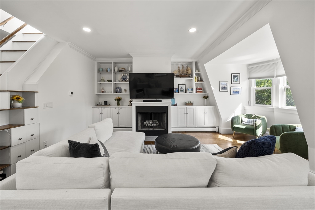 36 Upton Street, Unit 3 Boston, MA 02118 - Photo 11 of 33 a living room with furniture a flat screen tv and a fireplace