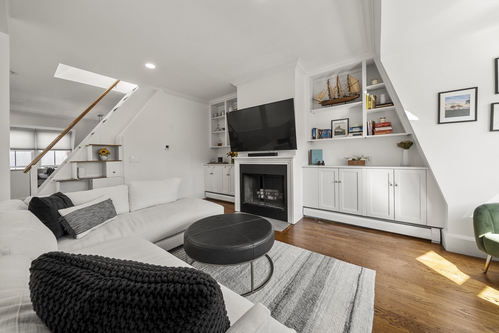 36 Upton Street, Unit 3 Boston, MA 02118 - Photo 12 of 33 a living room with furniture a flat screen tv and kitchen view
