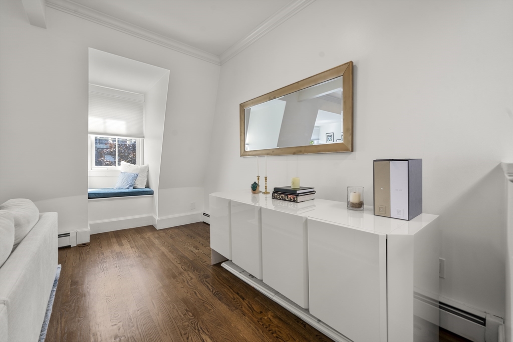 36 Upton Street, Unit 3 Boston, MA 02118 - Photo 17 of 33 a hallway with a computer on a desk and wooden floor