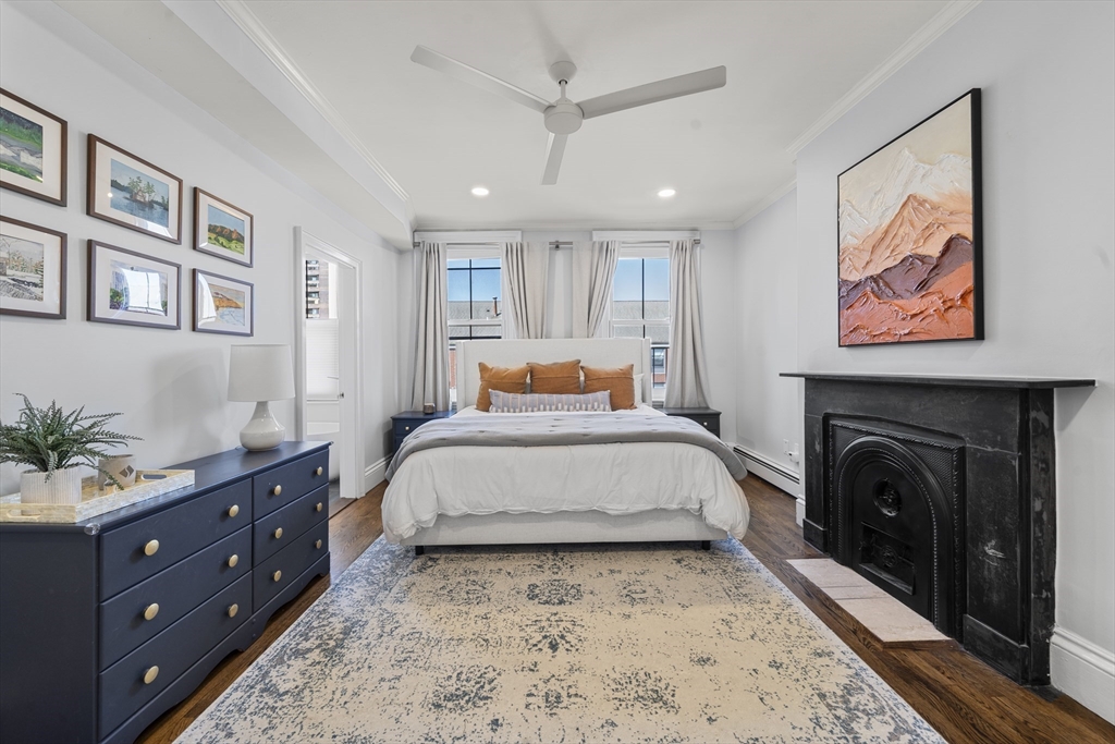 36 Upton Street, Unit 3 Boston, MA 02118 - Photo 18 of 33 a spacious bedroom with a bed and a chandelier