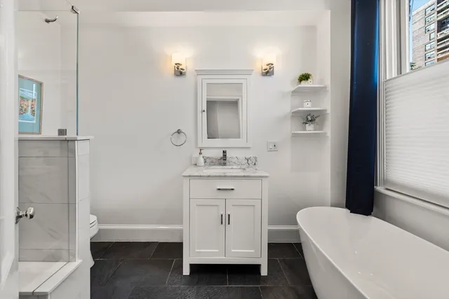 a bathroom with a sink a toilet and tub