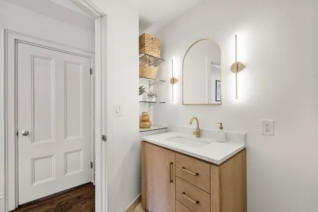 a bathroom with a double vanity sink and a mirror