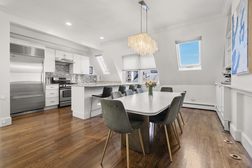 36 Upton Street, Unit 3 Boston, MA 02118 - Photo 3 of 33 a view of a dining room with furniture wooden floor and chandelier