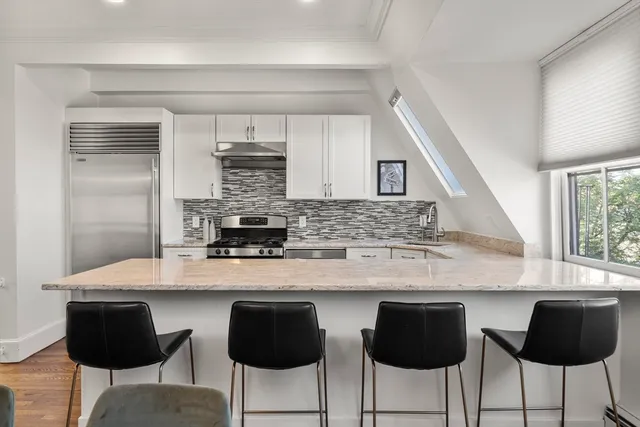 a kitchen with stainless steel appliances a sink and cabinets