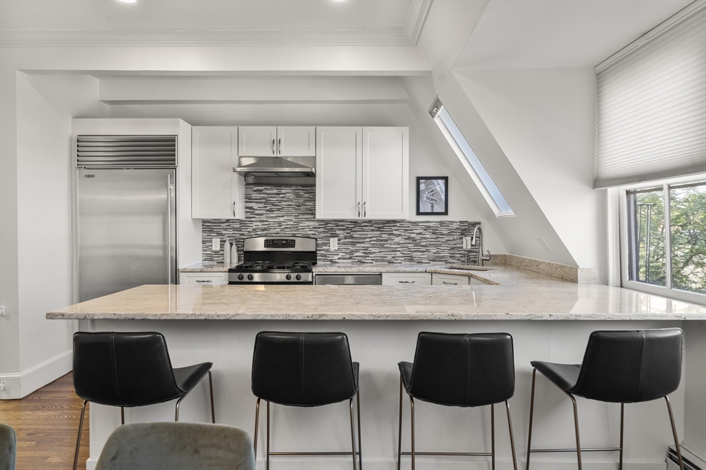36 Upton Street, Unit 3 Boston, MA 02118 - Photo 5 of 33 a kitchen with stainless steel appliances a sink and cabinets