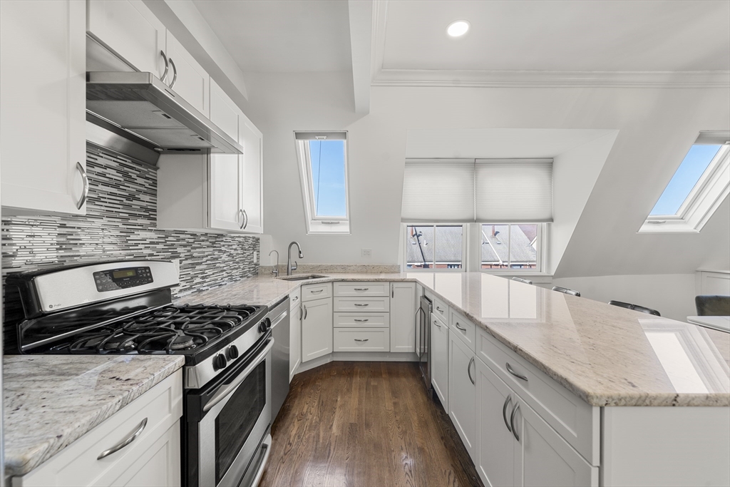 36 Upton Street, Unit 3 Boston, MA 02118 - Photo 6 of 33 a kitchen with granite countertop a sink stove and cabinets