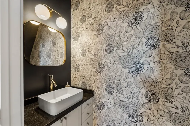 a bathroom with a sink and mirror