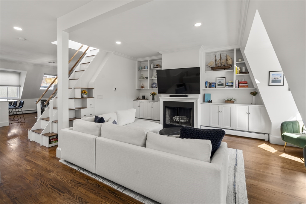 36 Upton Street, Unit 3 Boston, MA 02118 - Photo 10 of 33 a living room with furniture a flat screen tv and a fireplace