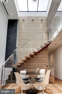 a living room with stainless steel appliances kitchen island granite countertop furniture a rug and a window