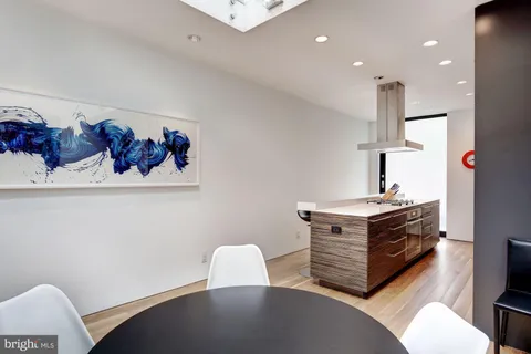 a kitchen with a table and chairs in it