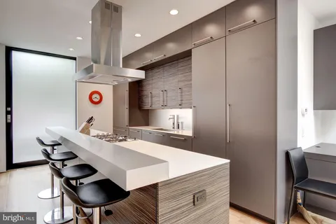 a kitchen with a sink a refrigerator and cabinets