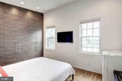a bedroom with a bed and a flat screen tv
