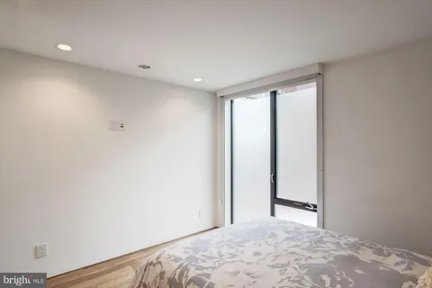 a bedroom with a bed and a chair