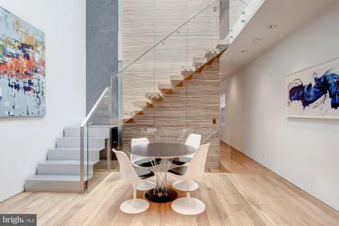 a balcony with chairs and wooden floor