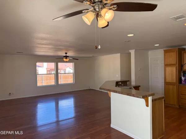a kitchen with stainless steel appliances granite countertop a stove a refrigerator a sink a microwave oven with wooden floor