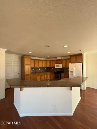 a view of a living room with kitchen island granite countertop wooden floor