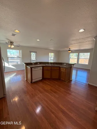 a view of kitchen and hall with wooden floor