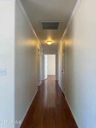 a view of a hallway with wooden floor