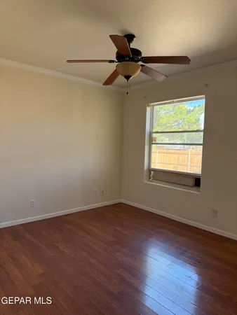 a view of a room with wooden floor cabinets and a window