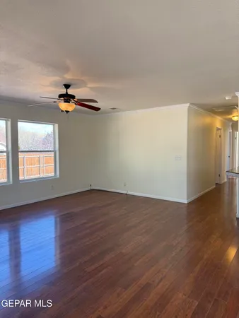 a view of an empty room with wooden floor