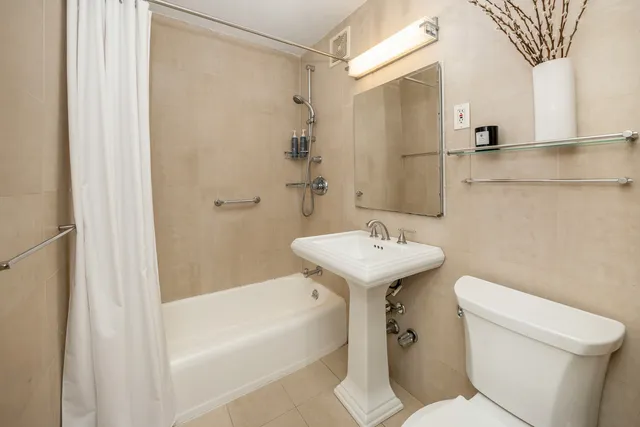 a bathroom with a sink toilet and shower