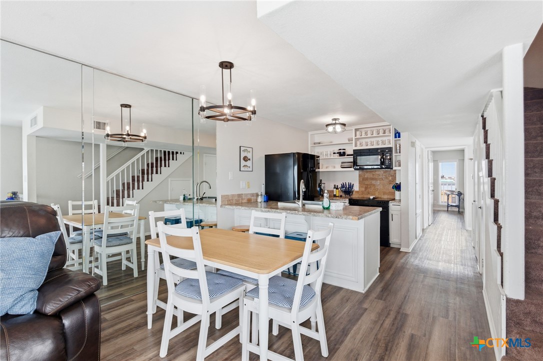 520 15th Street Port O'Connor, TX 77982 - Photo 17 of 36 a view of a dining room with furniture and wooden floor