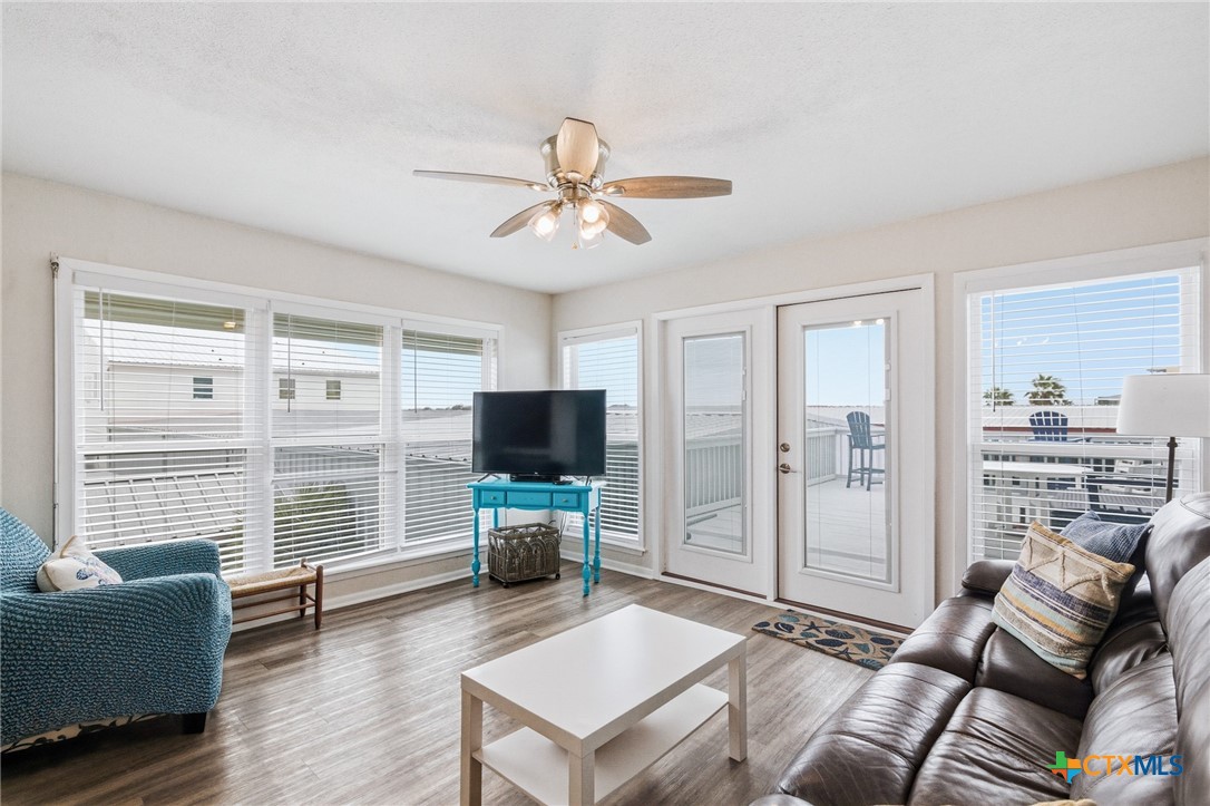 520 15th Street Port O'Connor, TX 77982 - Photo 20 of 36 a living room with furniture a flat screen tv and a large window