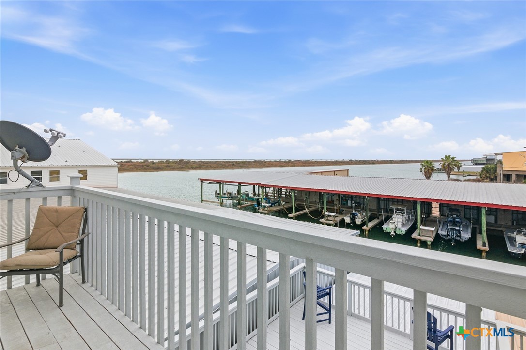 520 15th Street Port O'Connor, TX 77982 - Photo 26 of 36 a view of roof deck with two chairs and wooden floor