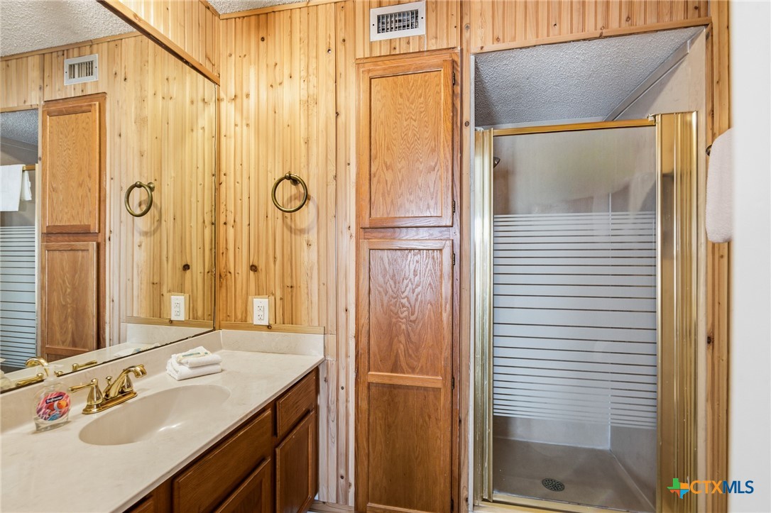520 15th Street Port O'Connor, TX 77982 - Photo 30 of 36 a bathroom with a shower sink and mirror