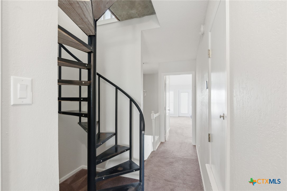 520 15th Street Port O'Connor, TX 77982 - Photo 33 of 36 a view of staircase with lots of frames on wall