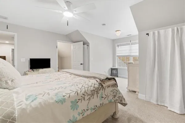 a view of a livingroom with a ceiling fan and window