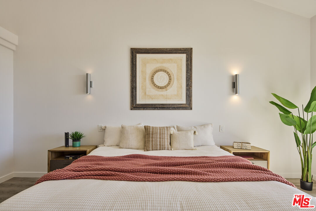 6465 Zuma View Place, Unit 163 Malibu, CA 90265 - Photo 14 of 26 a bedroom with a bed and a potted plant