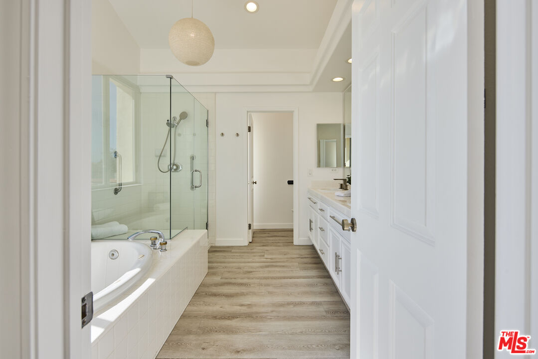 6465 Zuma View Place, Unit 163 Malibu, CA 90265 - Photo 16 of 26 a bathroom with a double vanity sink and mirror