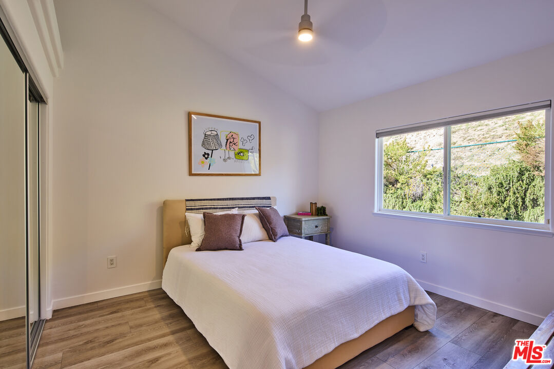 6465 Zuma View Place, Unit 163 Malibu, CA 90265 - Photo 20 of 26 a bedroom with a bed and a window