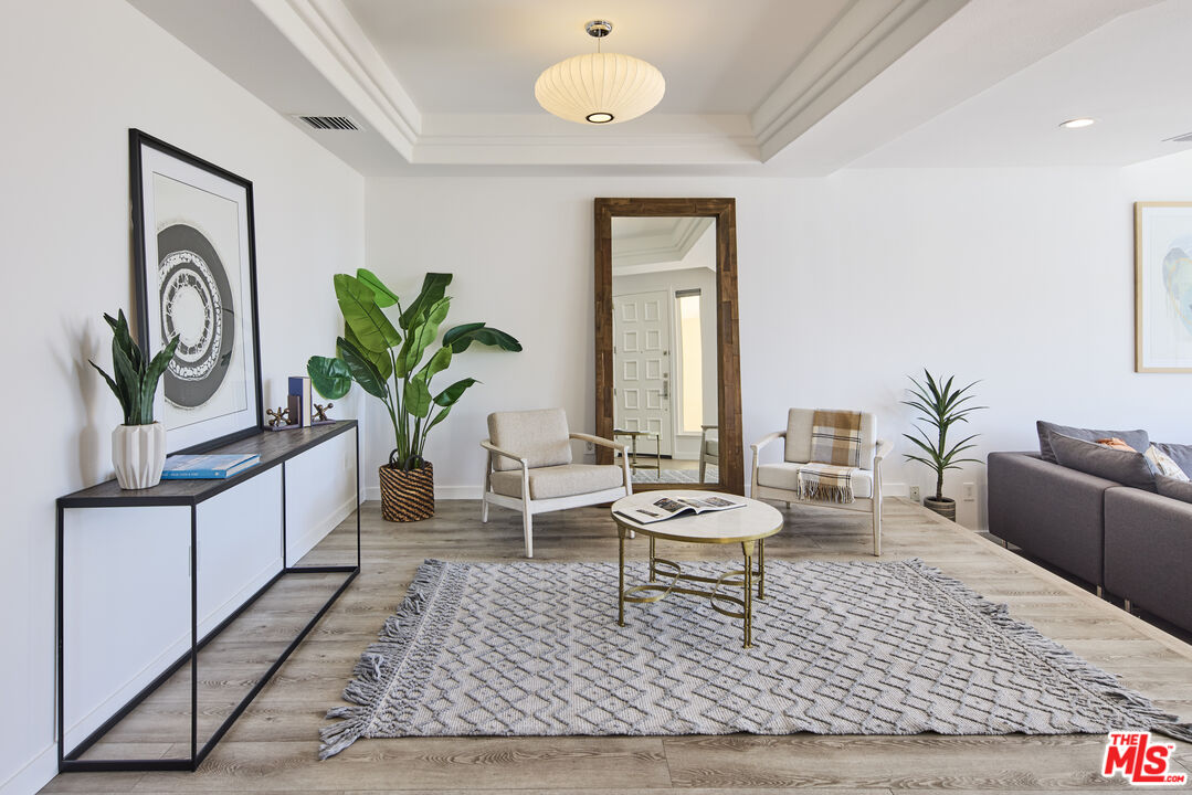 6465 Zuma View Place, Unit 163 Malibu, CA 90265 - Photo 2 of 26 a living room with furniture and a potted plant