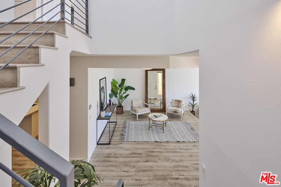6465 Zuma View Place, Unit 163 Malibu, CA 90265 - Photo 22 of 26 a view of a living room with furniture and a potted plant