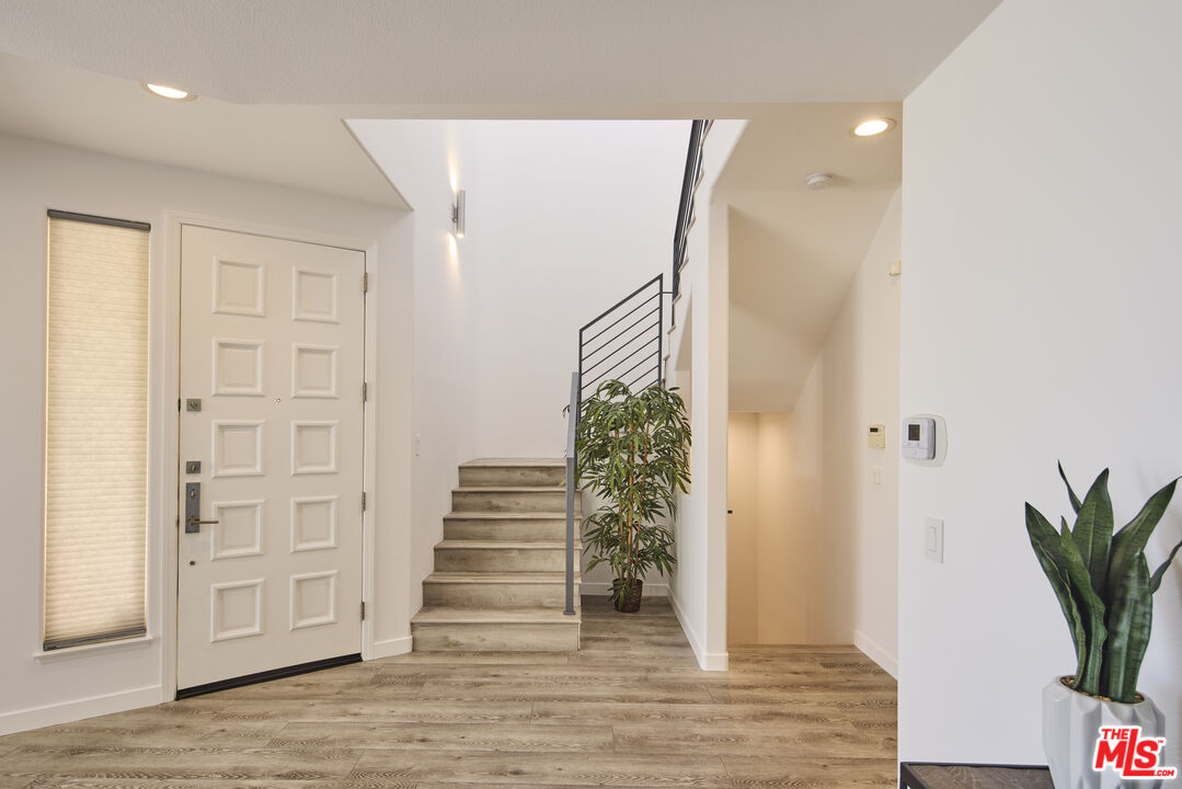 6465 Zuma View Place, Unit 163 Malibu, CA 90265 - Photo 3 of 26 a view of entryway with wooden floor and stairs