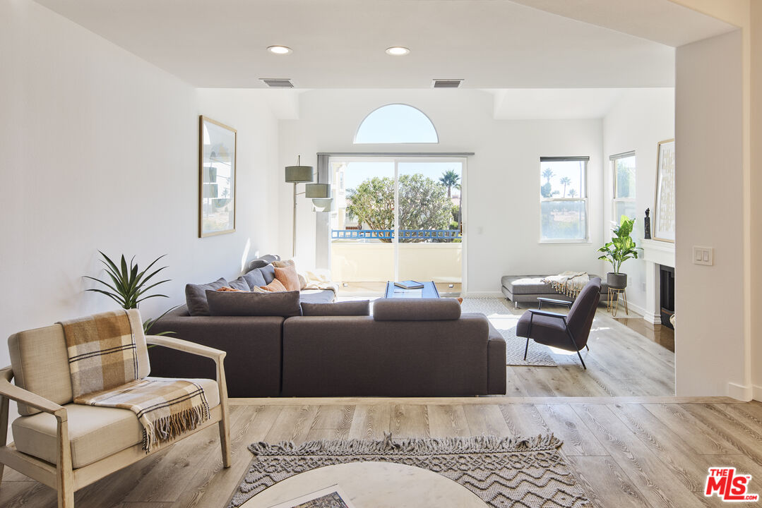 6465 Zuma View Place, Unit 163 Malibu, CA 90265 - Photo 4 of 26 a living room with furniture and a chandelier