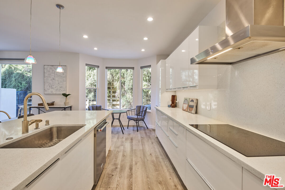 6465 Zuma View Place, Unit 163 Malibu, CA 90265 - Photo 7 of 26 a large white kitchen with sink and cabinets