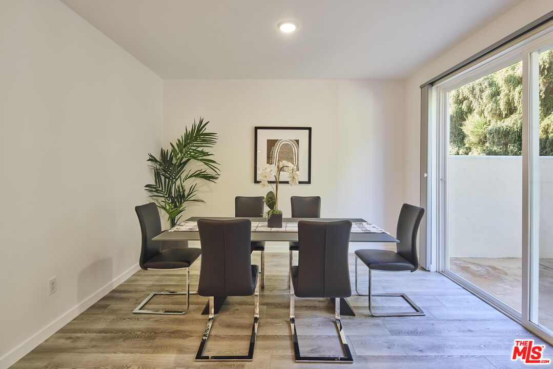 6465 Zuma View Place, Unit 163 Malibu, CA 90265 - Photo 10 of 26 a view of a dining room with furniture window and wooden floor