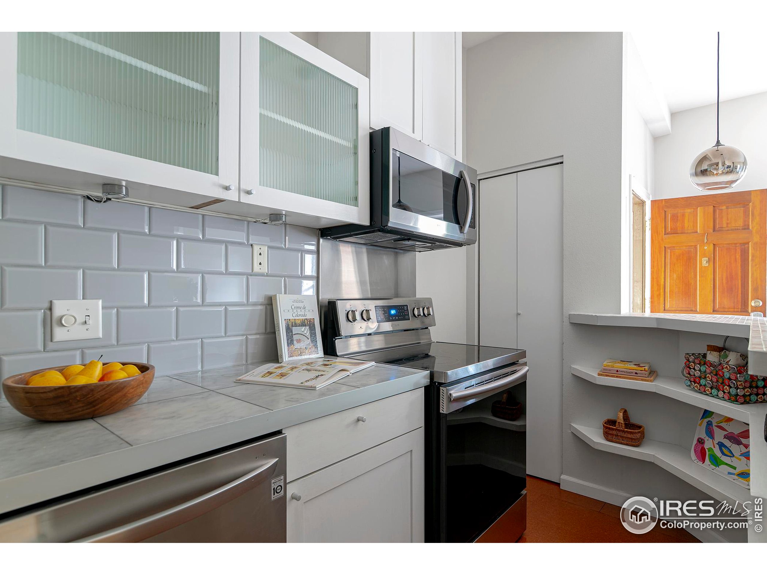 1237 Elder Avenue, Unit 1 Boulder, CO 80304 - Photo 5 of 15 a kitchen with stainless steel appliances a sink stove and cabinets