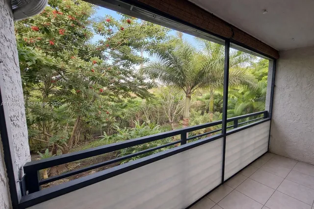 a view of a hallway with closet and a ceiling fan