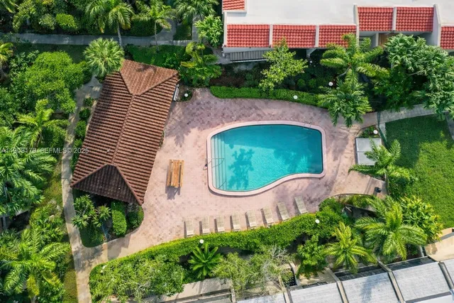 a view of a house with swimming pool and sitting area