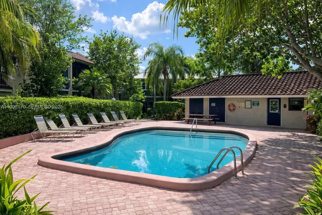 a view of a house with swimming pool and sitting area