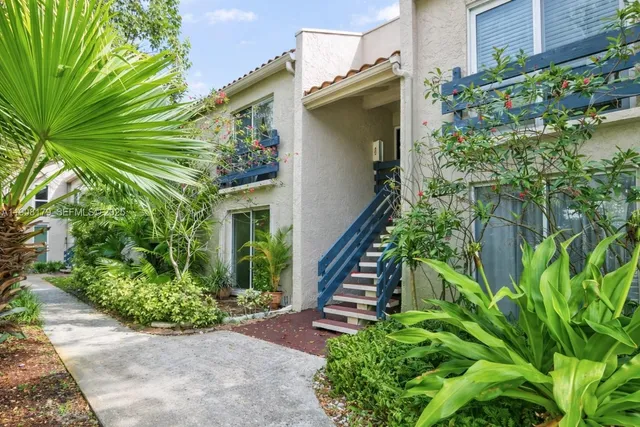 a view of a house with balcony and plants