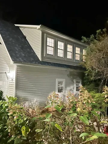 a view of a chair and table in backyard of the house