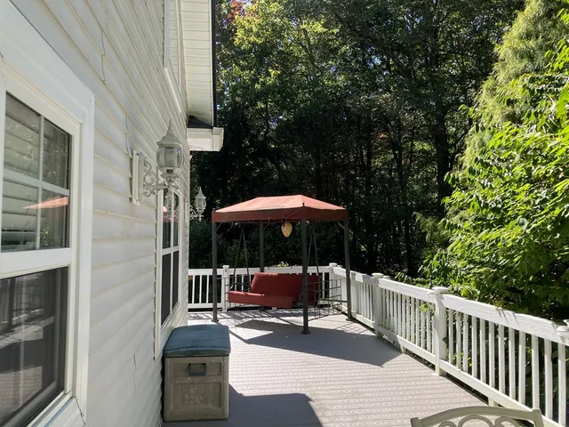 a view of balcony with wooden floor and outdoor seating
