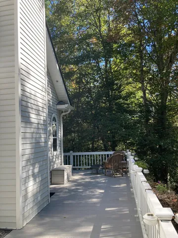 a view of a balcony with wooden floor and fence