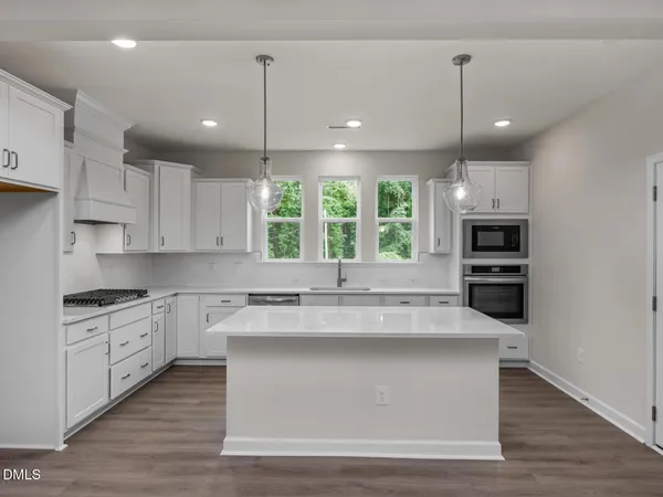 a kitchen with kitchen island granite countertop stainless steel appliances and oven