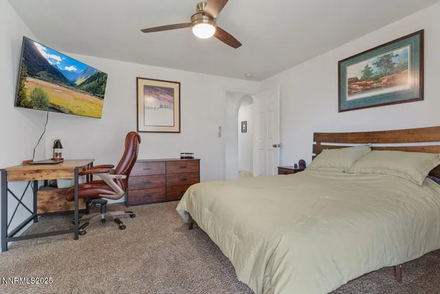 a bedroom with a bed and a desk